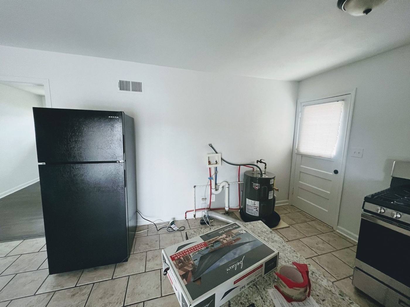 Before: unfinished laundry area